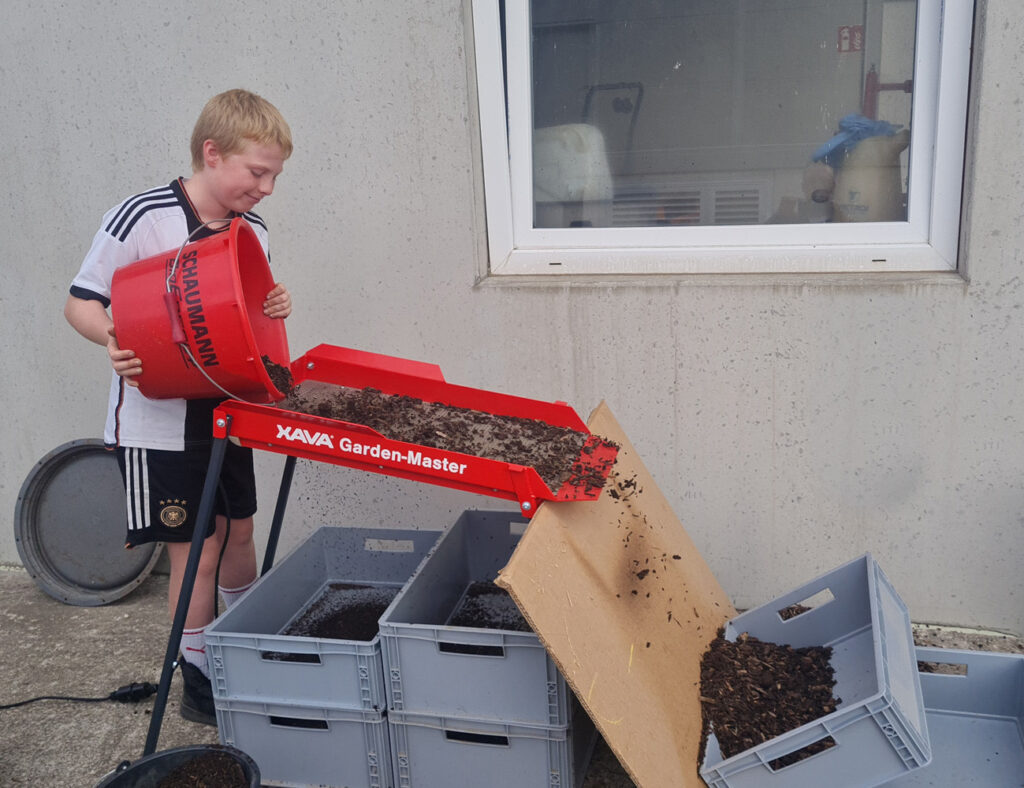 Jakob beim Kompost sieben